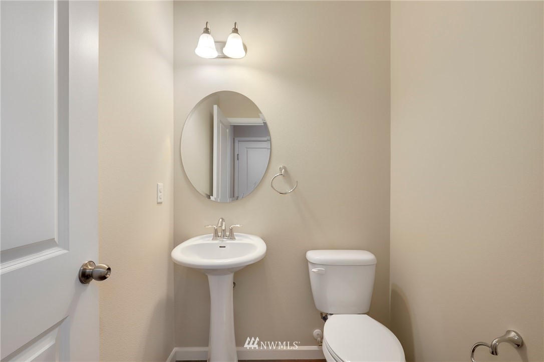 7301 Radius Loop Southeast Lacey, WA 98513 - Photo 15 of 39 a bathroom with a toilet sink and mirror