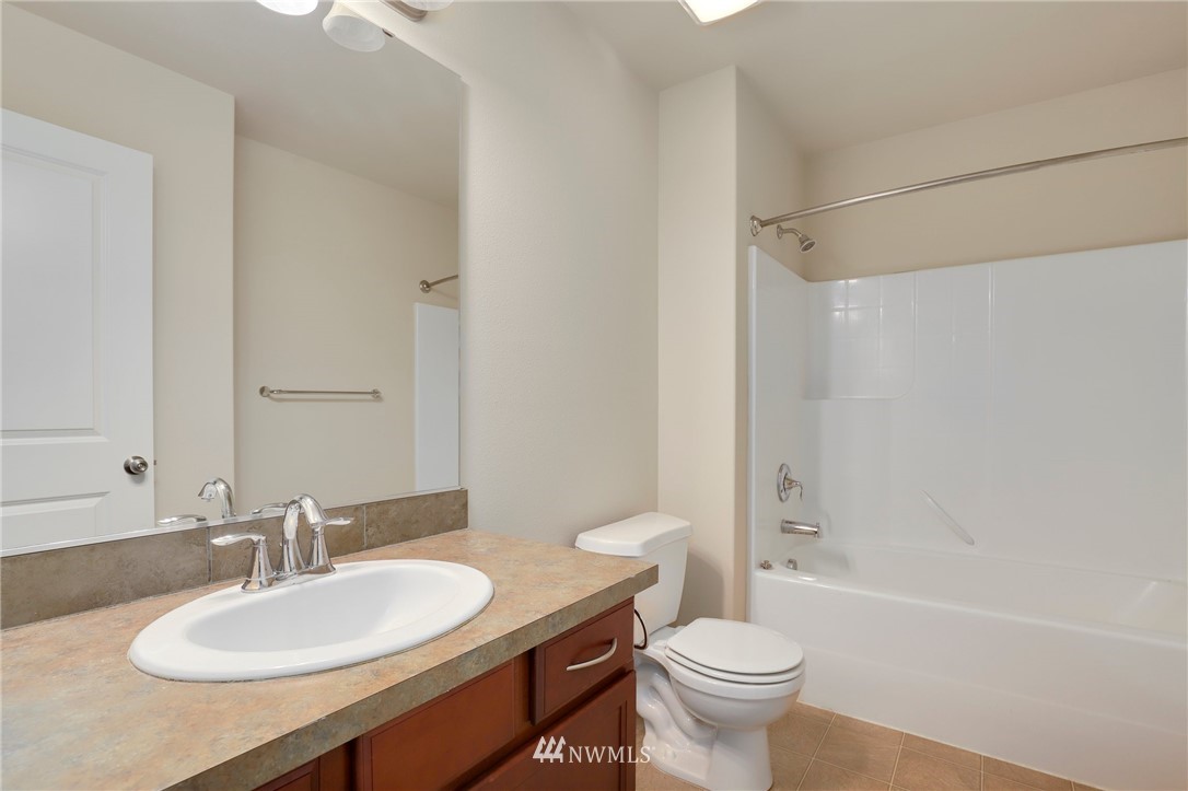 7301 Radius Loop Southeast Lacey, WA 98513 - Photo 17 of 39 a bathroom with a sink a toilet and a mirror