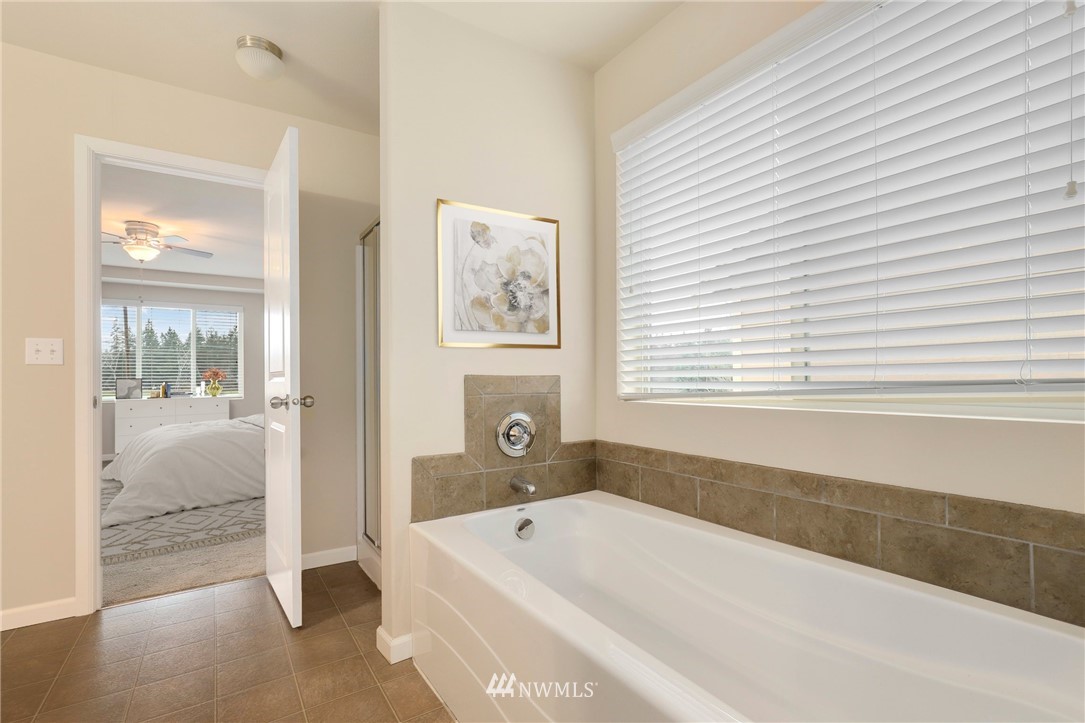 7301 Radius Loop Southeast Lacey, WA 98513 - Photo 22 of 39 a bathroom with a bathtub and a shower