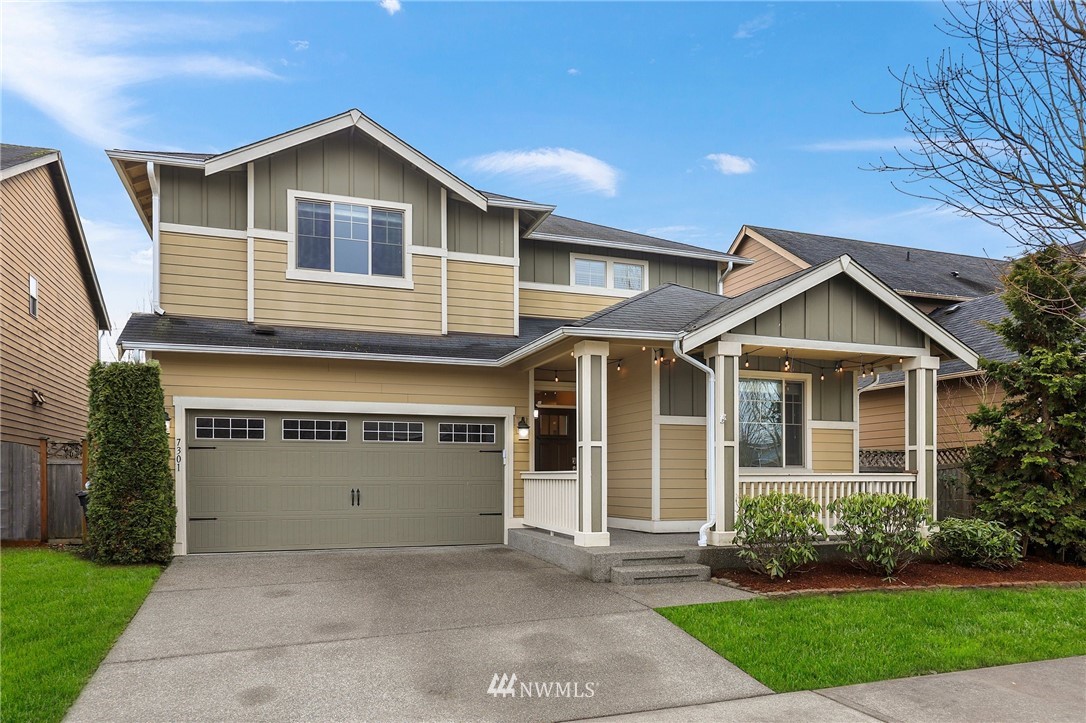 7301 Radius Loop Southeast Lacey, WA 98513 - Photo 37 of 39 a front view of a house with a yard and garage