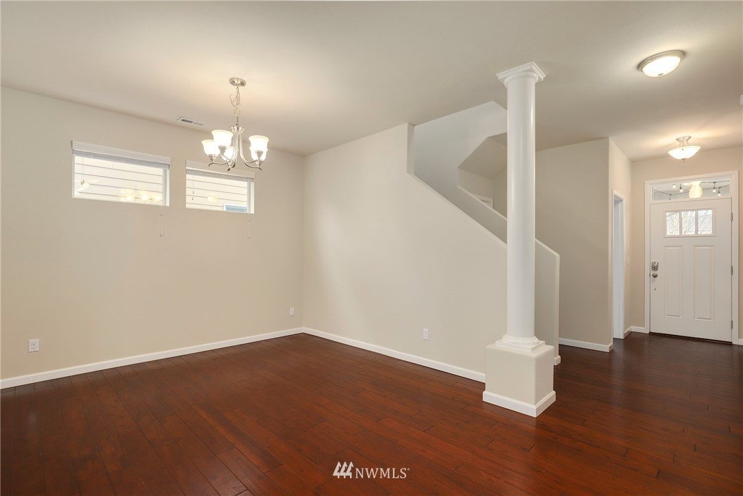 7301 Radius Loop Southeast Lacey, WA 98513 - Photo 4 of 39 wooden floor in an empty room with a window