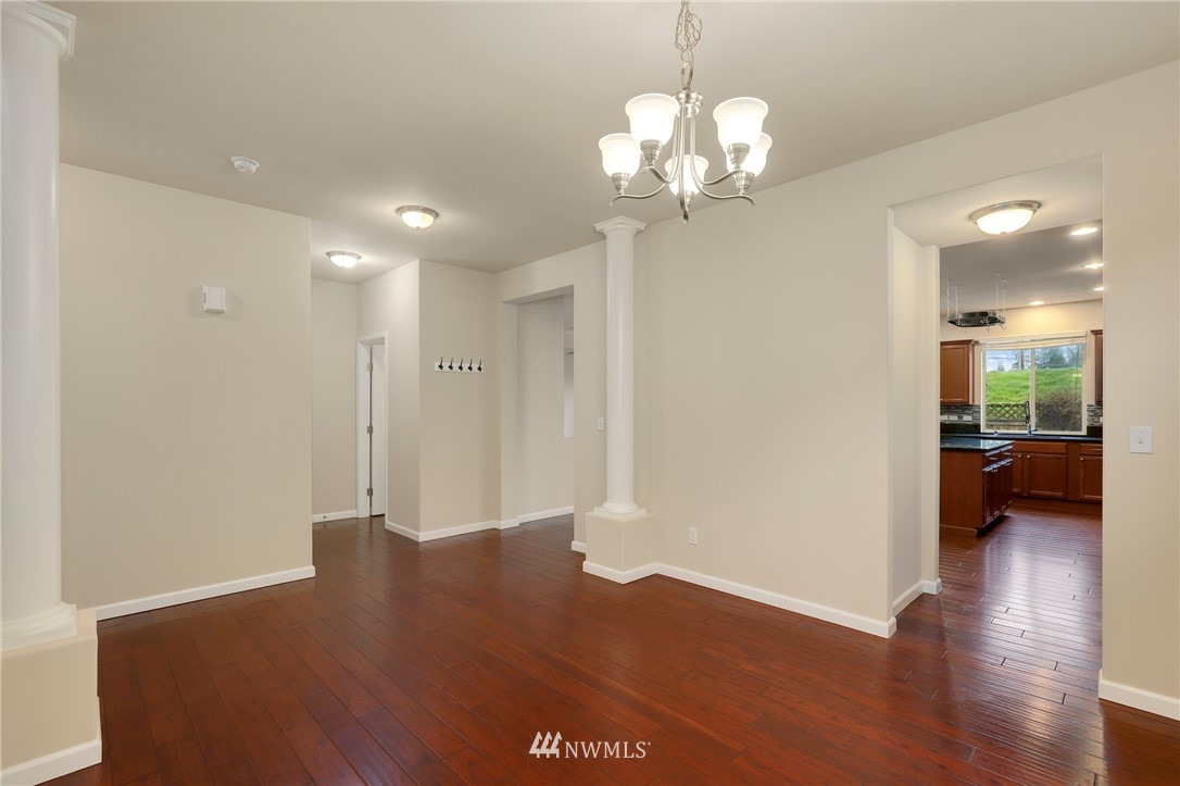 7301 Radius Loop Southeast Lacey, WA 98513 - Photo 5 of 39 a view of a hallway with wooden floor and a large mirror