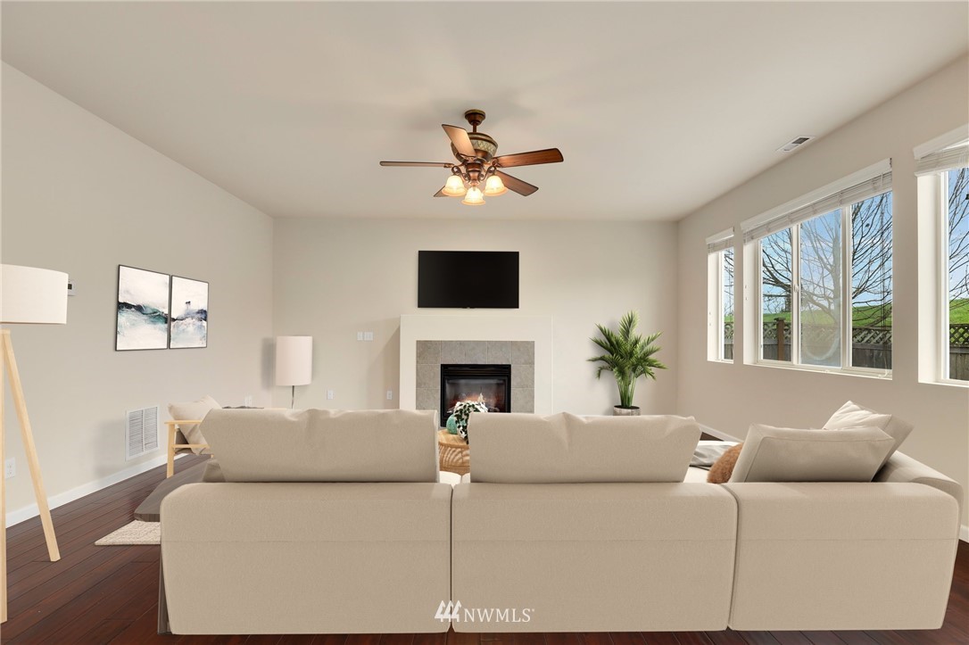 7301 Radius Loop Southeast Lacey, WA 98513 - Photo 8 of 39 a living room with furniture a fireplace and a large window