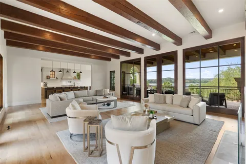 a living room with furniture and large windows