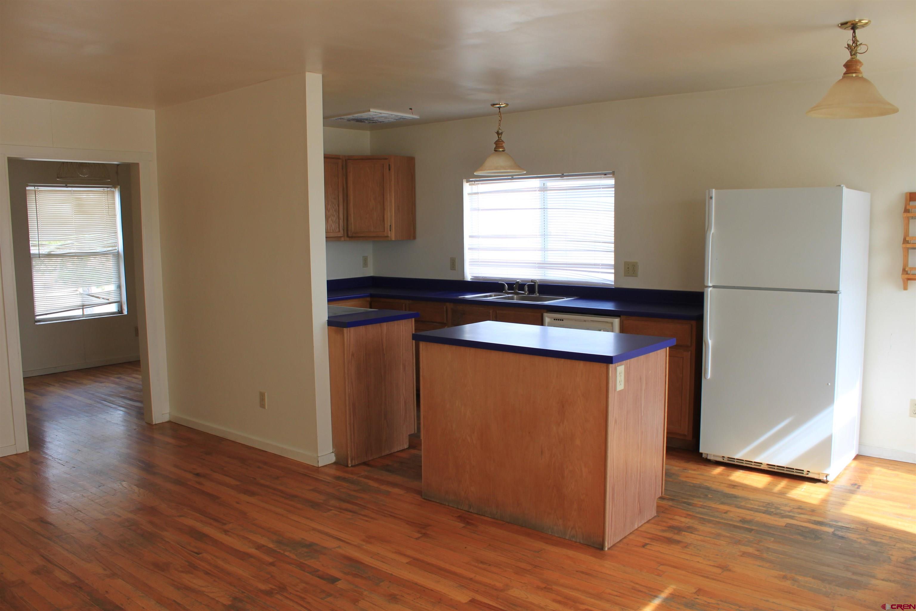 13580 25 Mesa Road Delta, CO 81416 - Photo 30 of 33 a kitchen with granite countertop wooden floors and a white sink