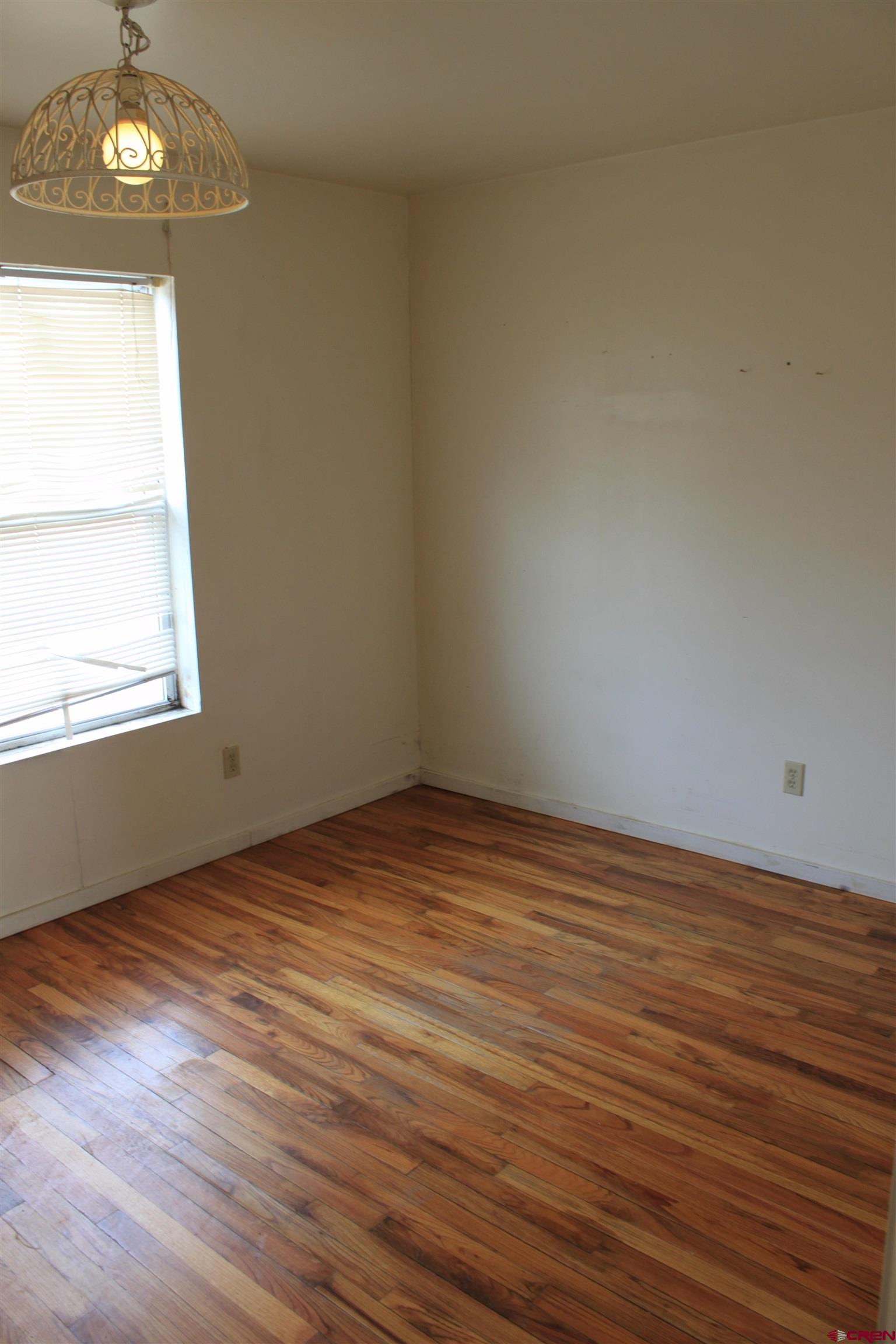 13580 25 Mesa Road Delta, CO 81416 - Photo 31 of 33 an empty room with wooden floor and windows