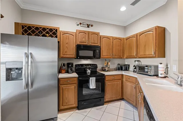 a kitchen with stainless steel appliances a dining table and chairs