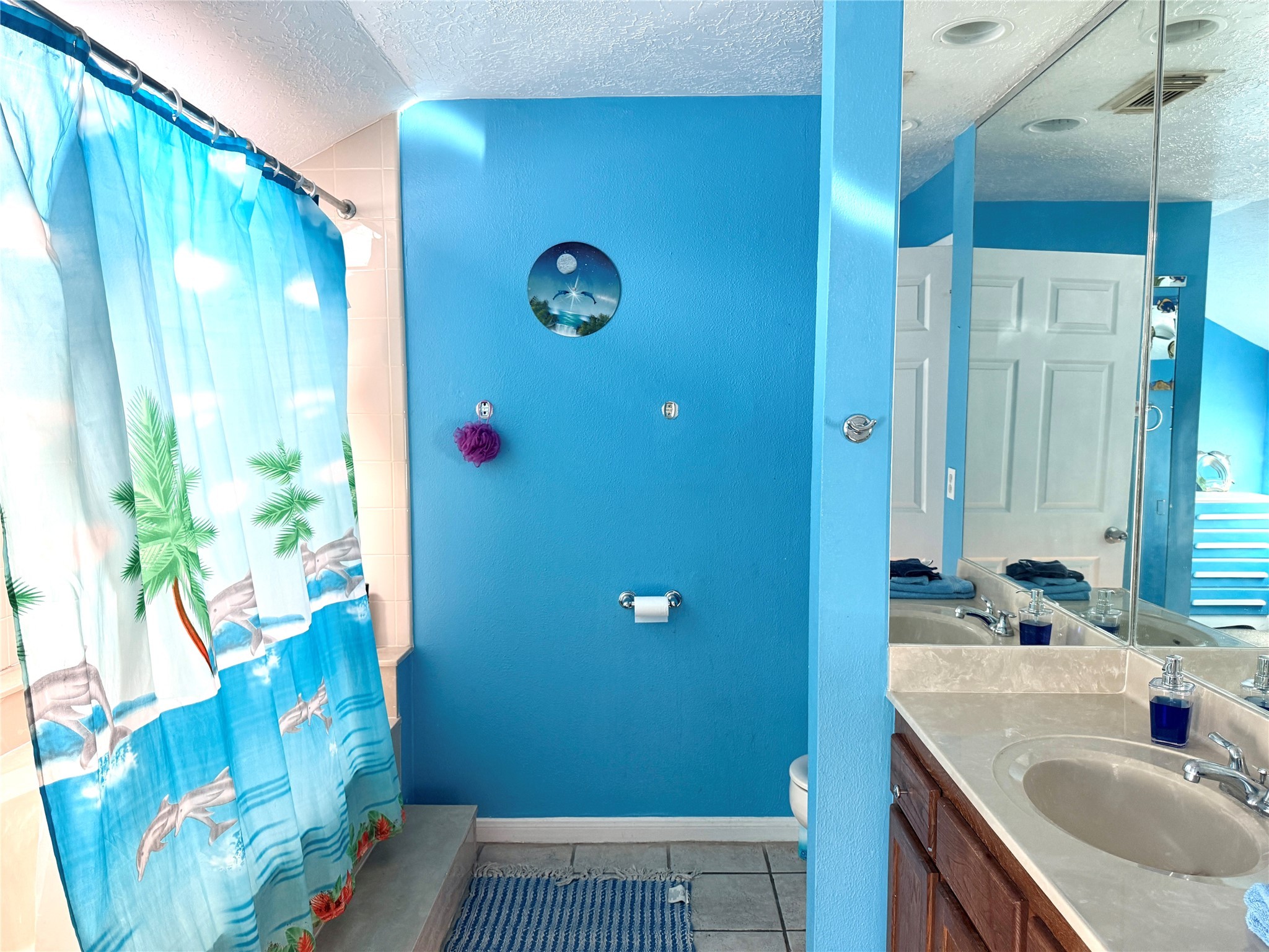 7041 Kingston Cove Lane, Unit 241 Willis, TX 77318 - Photo 11 of 17 a bathroom with a sink and a mirror