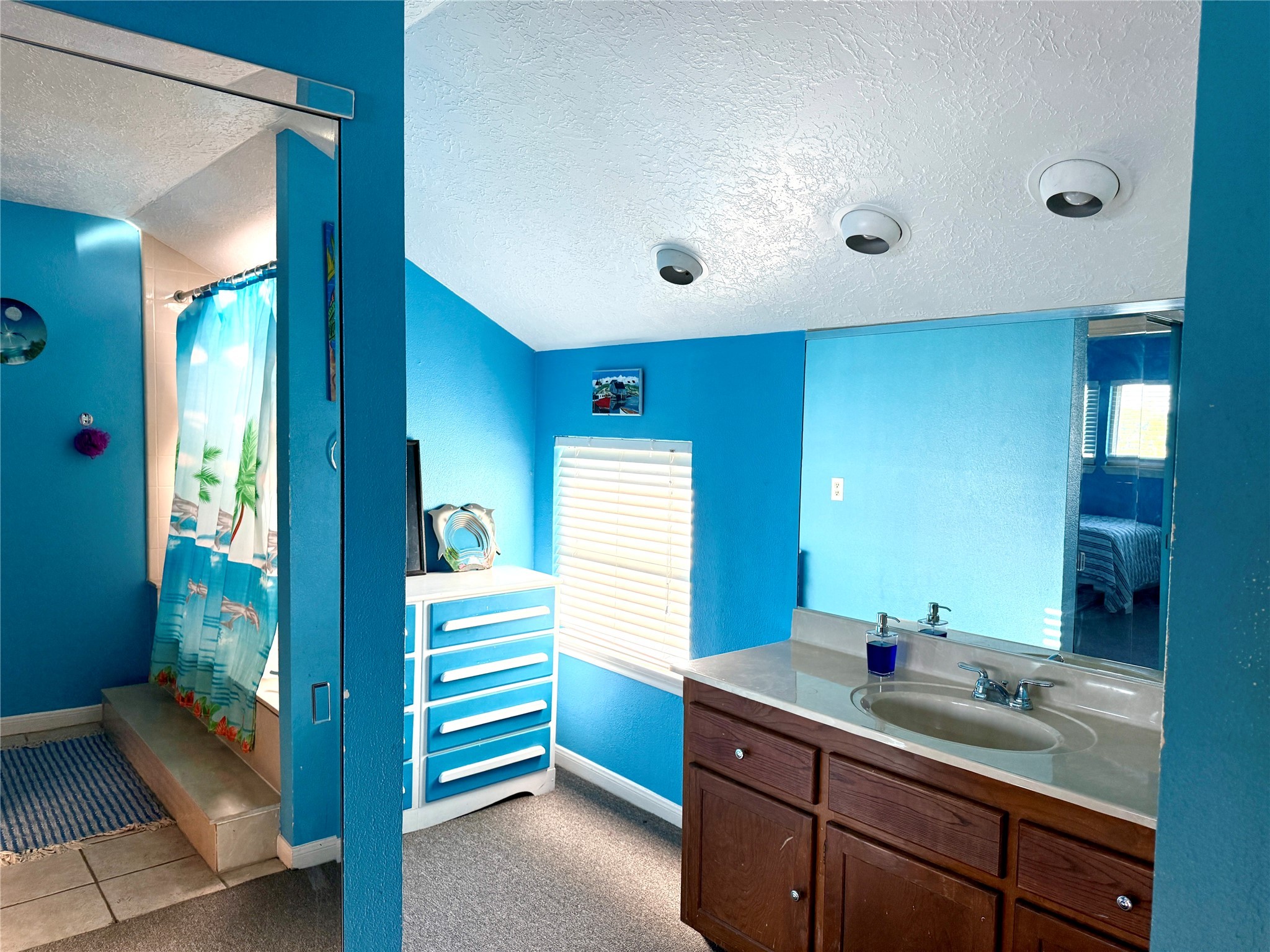 7041 Kingston Cove Lane, Unit 241 Willis, TX 77318 - Photo 12 of 17 a bathroom with a double vanity sink and a mirror