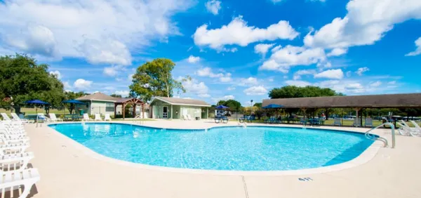 a view of a house with swimming pool and sitting area