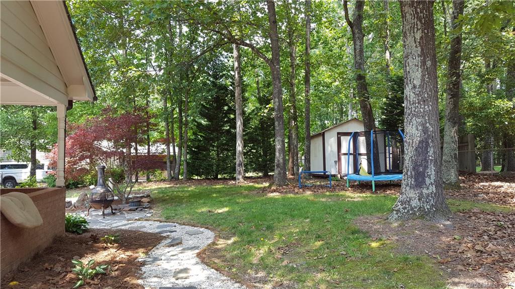 1130 Foxberry Road Lincolnton, NC 28092 - Photo 20 of 22 a backyard of a house with garden and outdoor seating