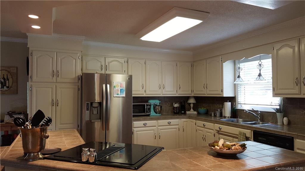 1130 Foxberry Road Lincolnton, NC 28092 - Photo 7 of 22 a kitchen with kitchen island granite countertop a refrigerator and a sink