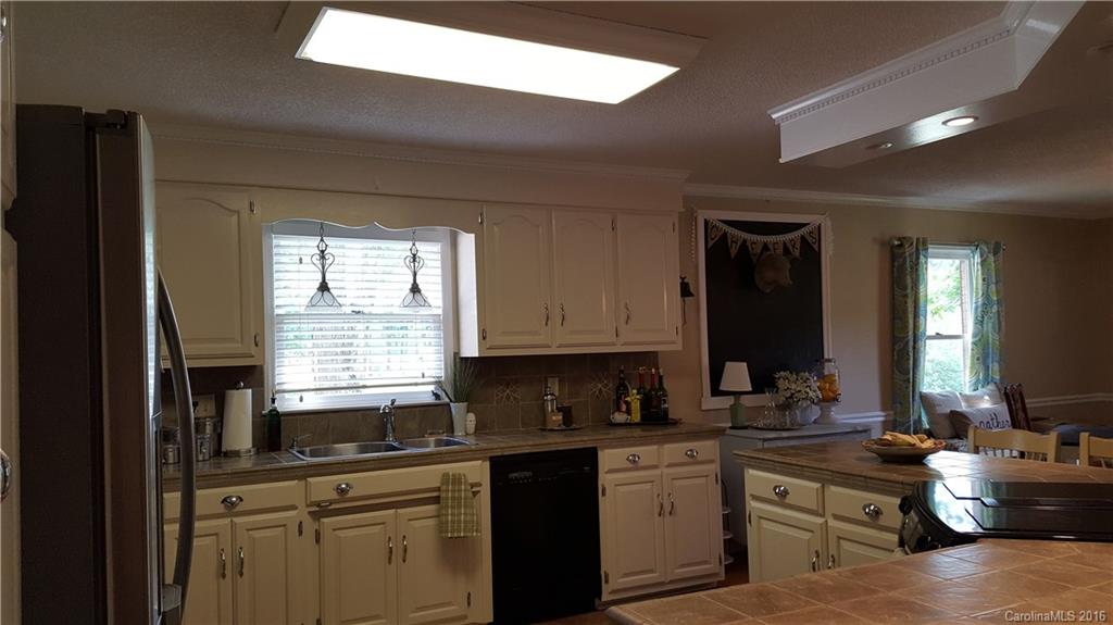1130 Foxberry Road Lincolnton, NC 28092 - Photo 8 of 22 a kitchen with furniture a sink a stove and cabinets