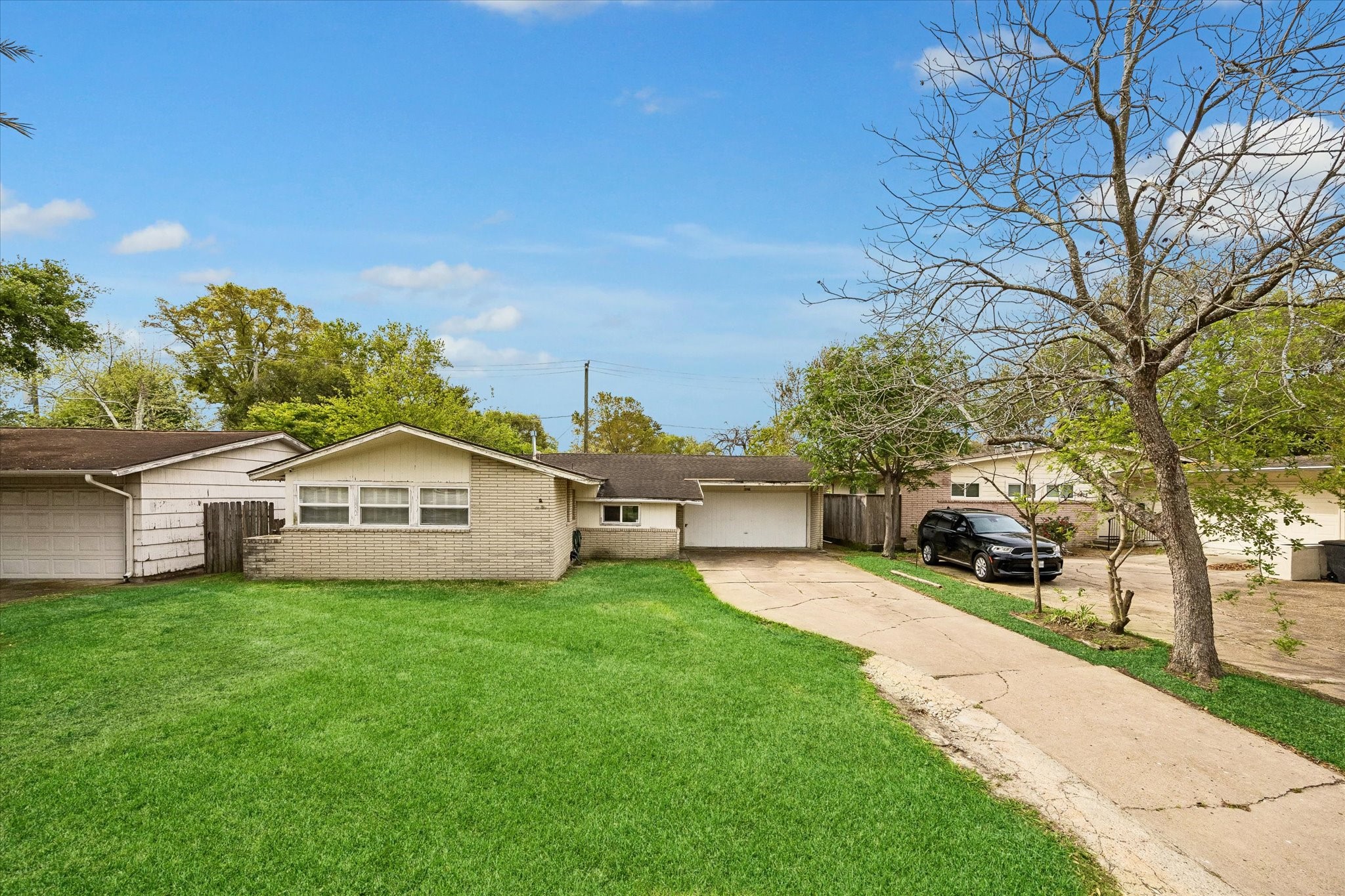 a view of a house with a yard and sitting area