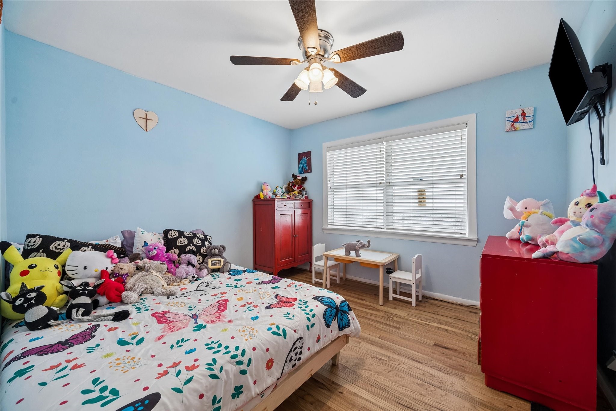 6821 Leader Street Houston, TX 77074 - Photo 11 of 14 a bedroom with a bed and wooden floor