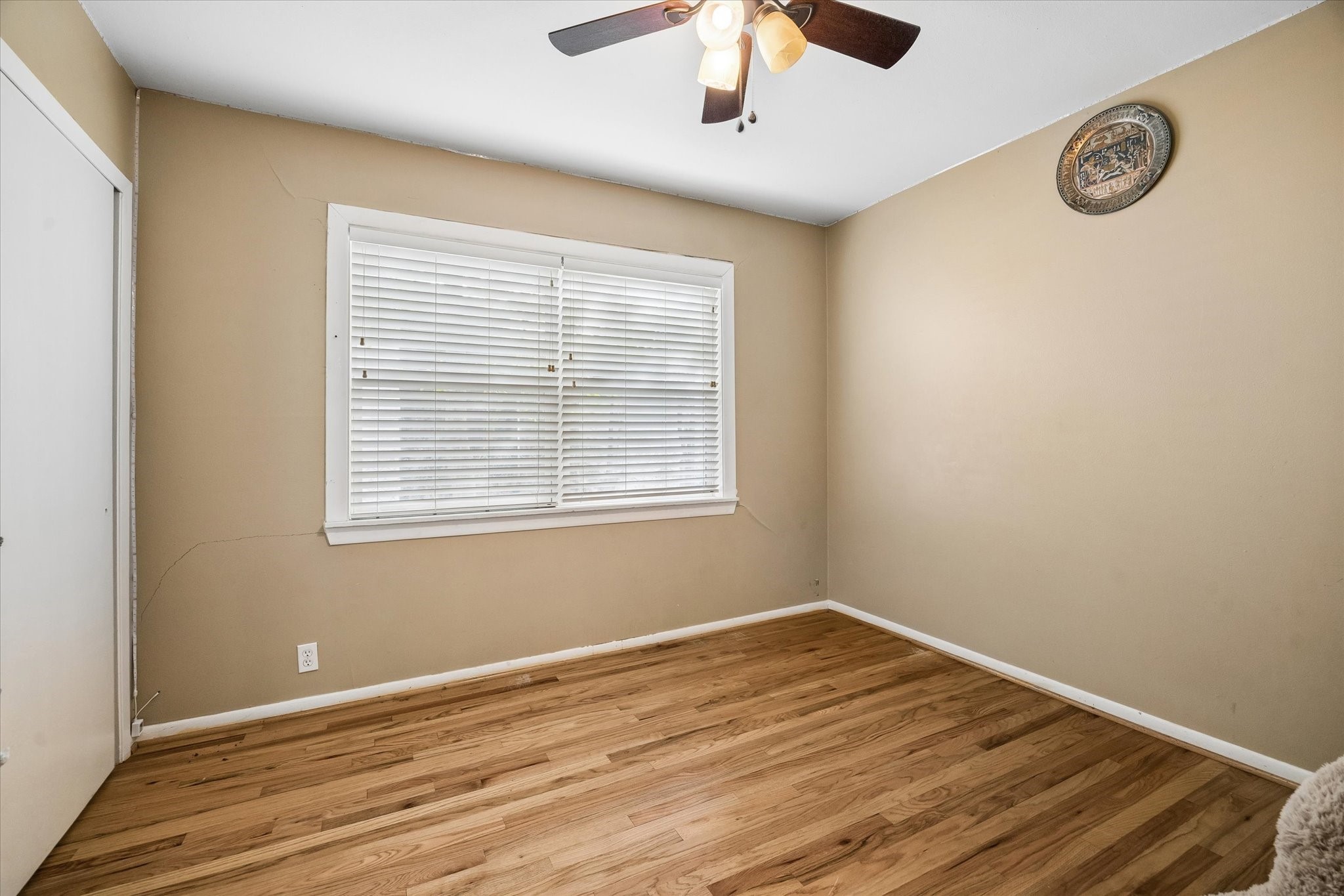 6821 Leader Street Houston, TX 77074 - Photo 12 of 14 a view of an empty room with wooden floor and a window