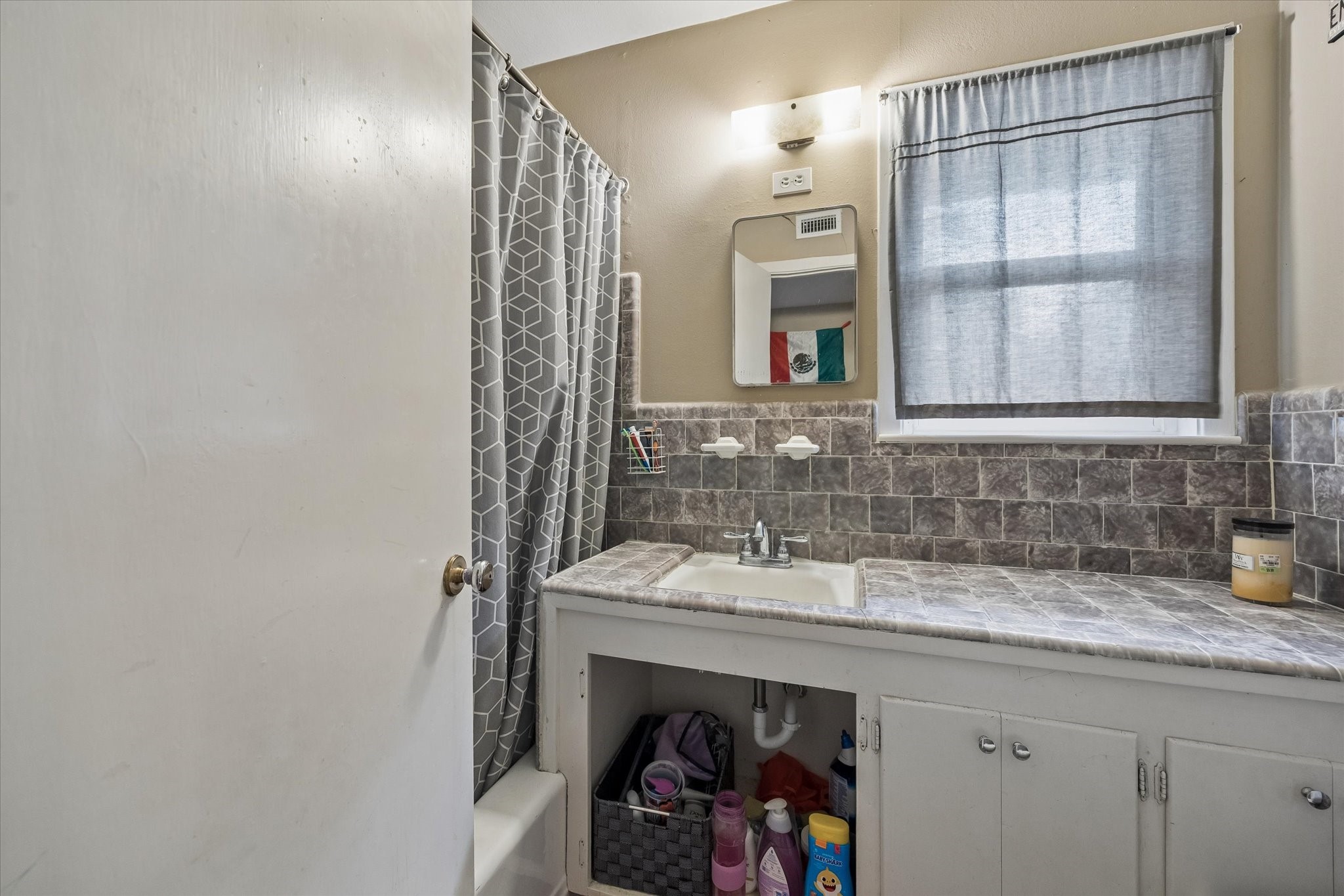 6821 Leader Street Houston, TX 77074 - Photo 13 of 14 a bathroom with a sink and a mirror