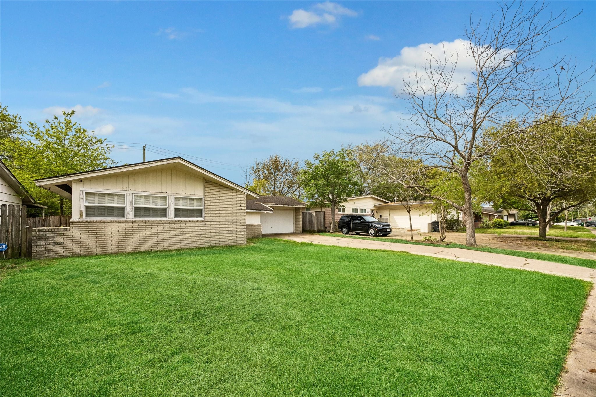 6821 Leader Street Houston, TX 77074 - Photo 2 of 14 a front view of a house with a yard and garage