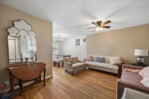 a living room with furniture a fireplace and a chandelier
