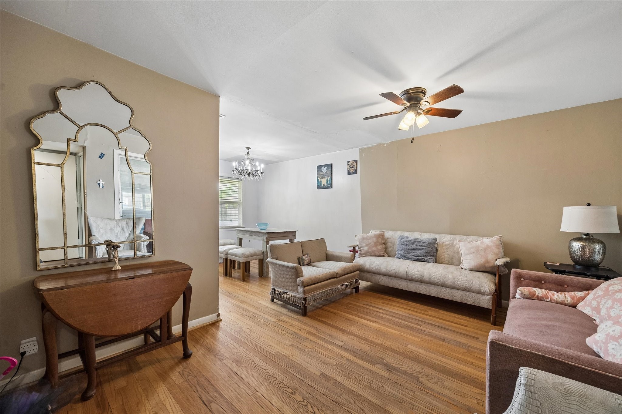 6821 Leader Street Houston, TX 77074 - Photo 4 of 14 a living room with furniture a fireplace and a chandelier