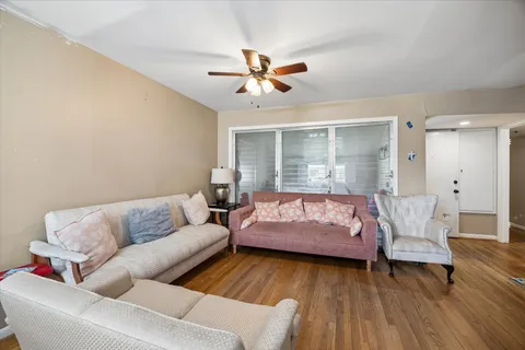 a living room with furniture and wooden floor