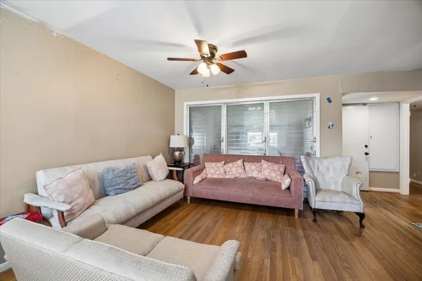 a living room with furniture and wooden floor