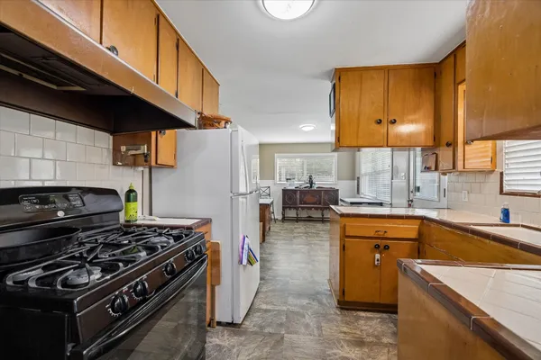 a kitchen with a stove a sink and a microwave