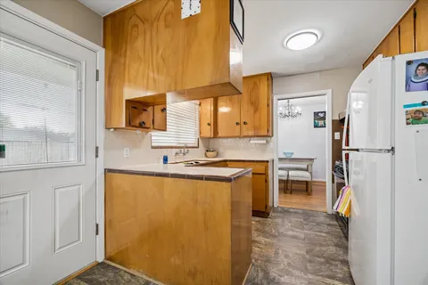 a kitchen with stainless steel appliances granite countertop a refrigerator a stove and a sink