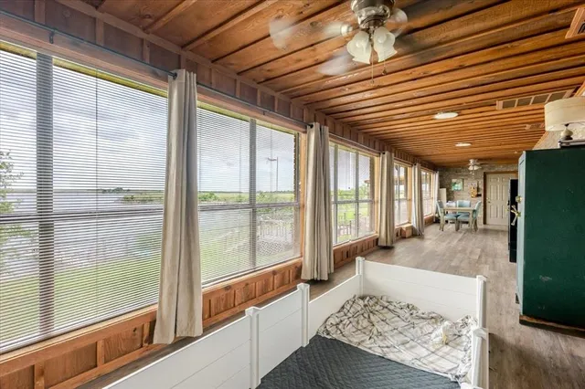 a spacious bedroom with a bed and a chandelier