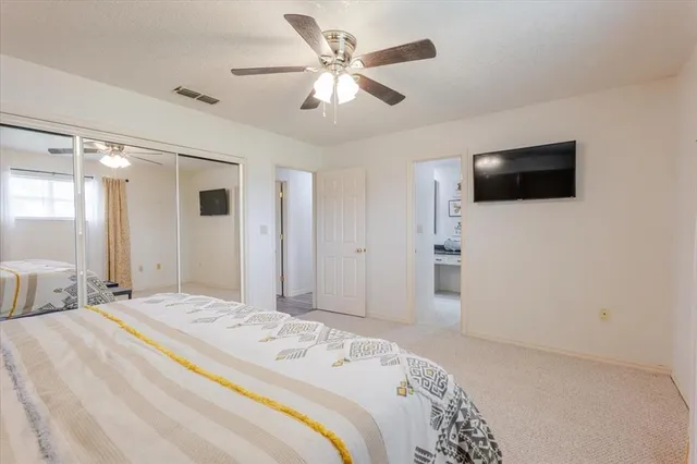 a bathroom with double vanity sinks a mirror and a window