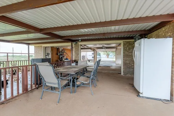 a view of roof deck with seating area and barbeque oven