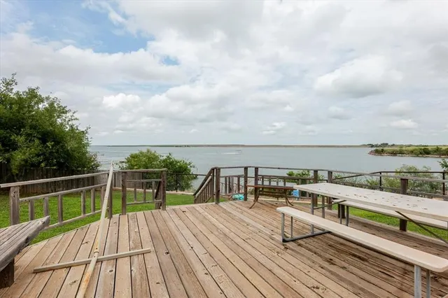 a view of a house with a big yard and large trees