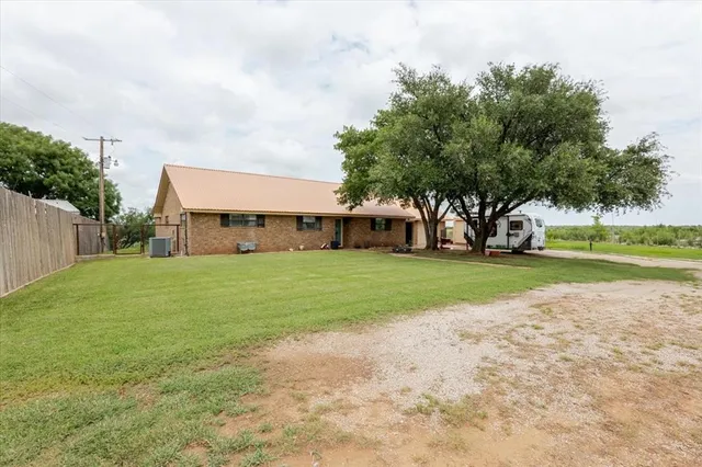 a view of a house with a big yard and garden