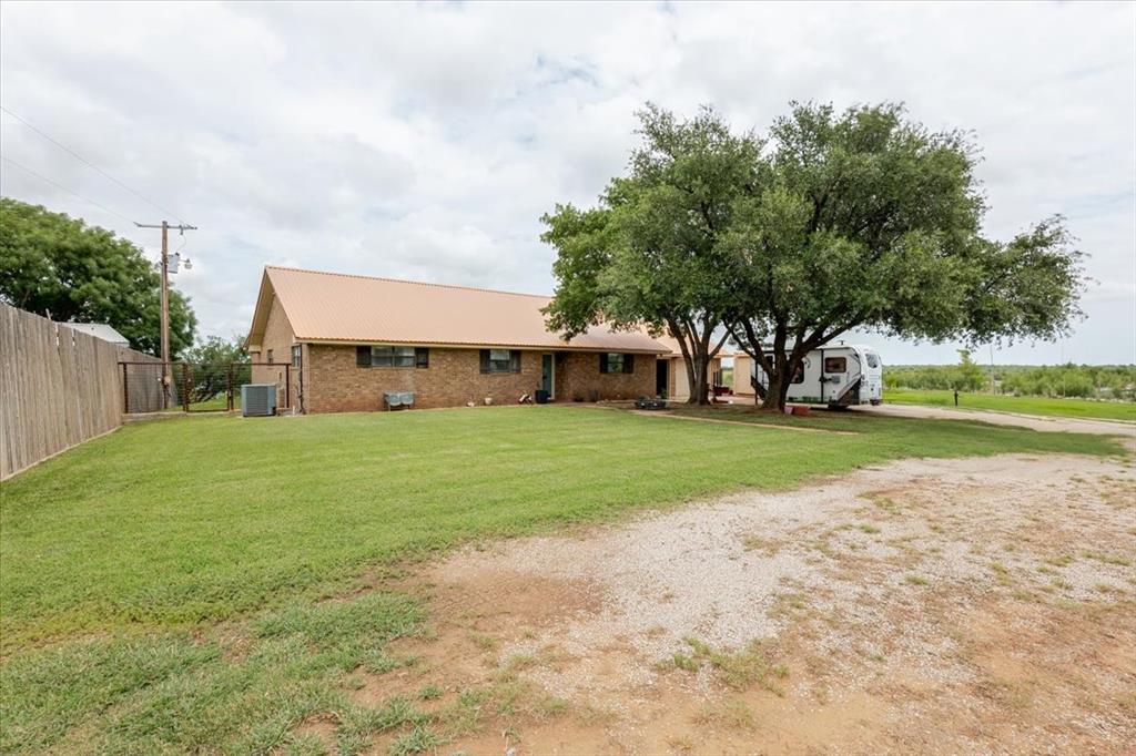 199 Willingham Loop Seymour, TX 76380 - Photo 3 of 40 a view of a house with a big yard and garden