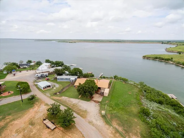 an aerial view of lake and houses with outdoor space