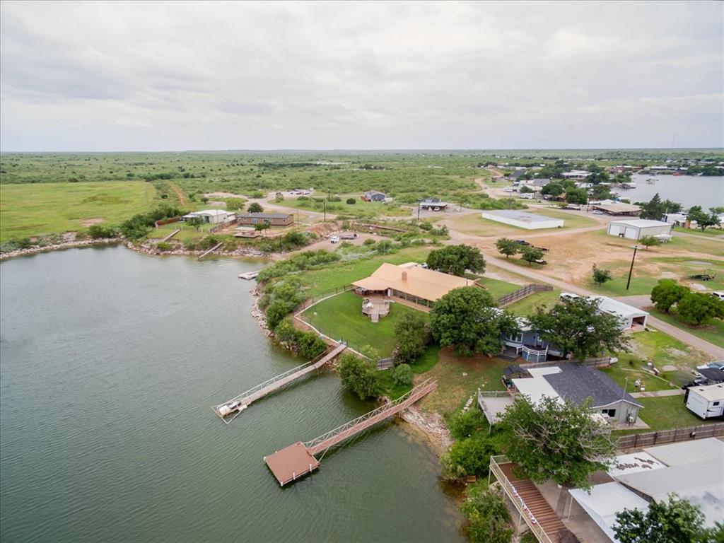 199 Willingham Loop Seymour, TX 76380 - Photo 38 of 40 an aerial view of residential houses with outdoor space and lake view in back