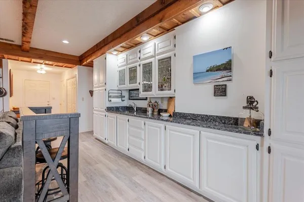 a kitchen with granite countertop a sink and cabinets