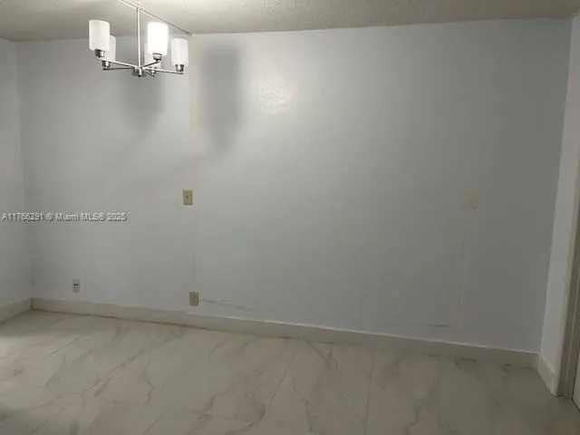 an empty room with a empty space and windows