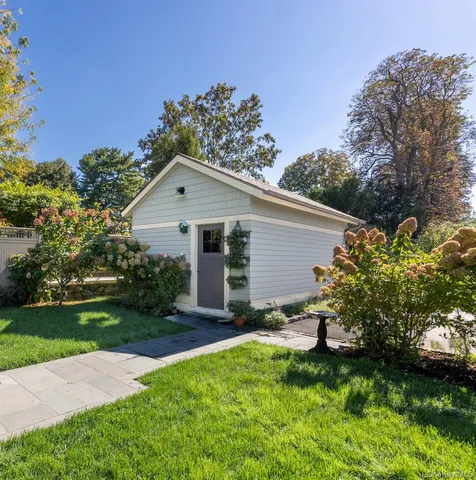 a backyard of a house with table and chairs