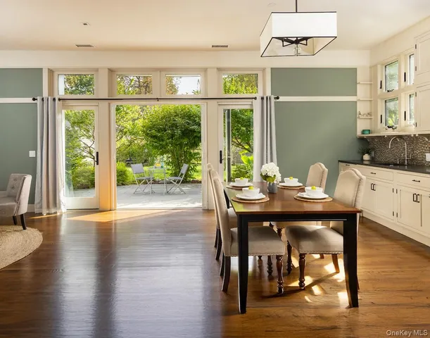 a open dining room with furniture window and wooden floor