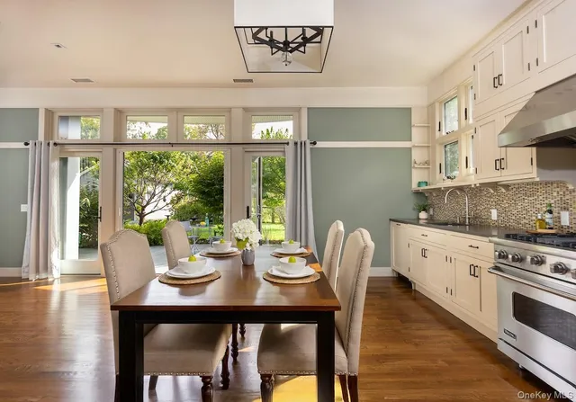 a kitchen with granite countertop white cabinets and a stainless steel appliances