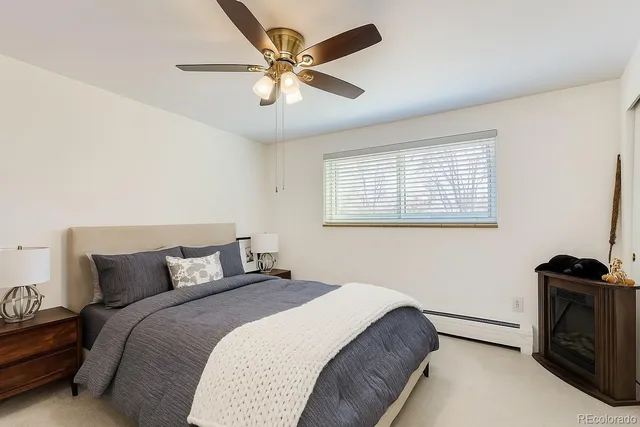 a bedroom with a bed and a ceiling fan
