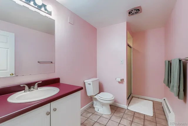 a bathroom with a sink toilet and mirror