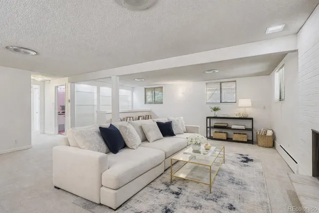 a dining room with furniture and a kitchen view