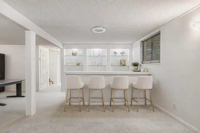 a bathroom with a sink vanity mirror and toilet