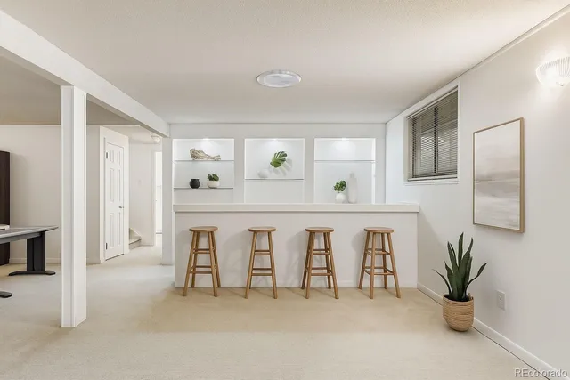 a spacious bedroom with furniture and a potted plant