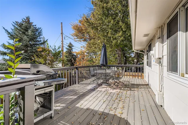 a view of balcony with wooden floor and seating