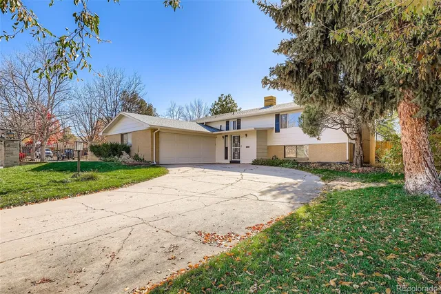 a front view of a house with a yard and a garage