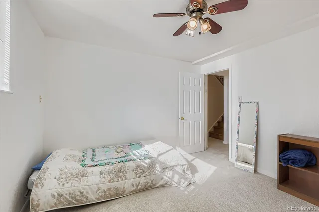 a bed sitting in a bedroom and chair