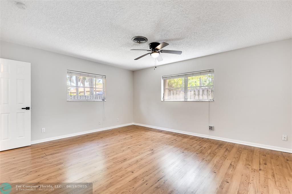 3460 Northeast 28th Avenue Lighthouse Point, FL 33064 - Photo 11 of 37 a view of empty room with wooden floor and fan